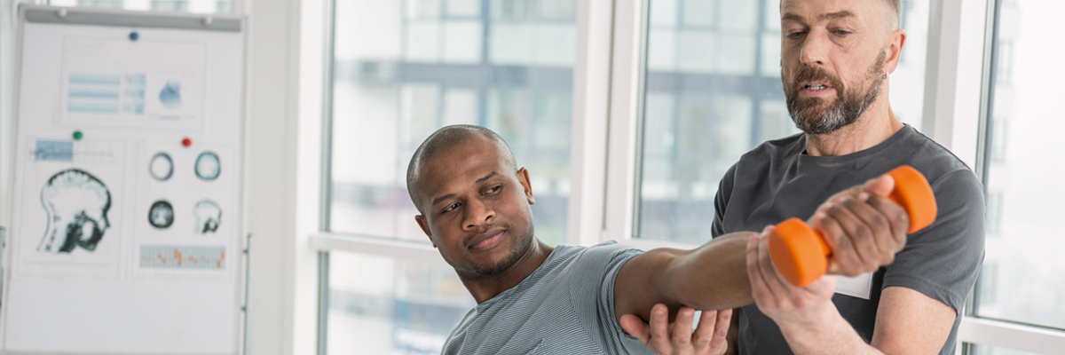 man with weight and trainer