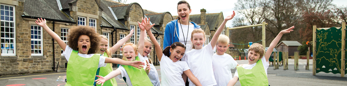 smiling elementary-aged students outside