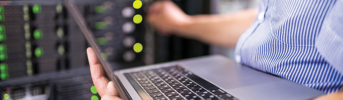 man holding laptop working on networks