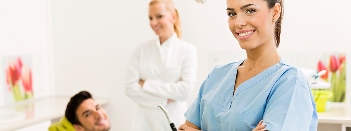 dental hygienist with patient