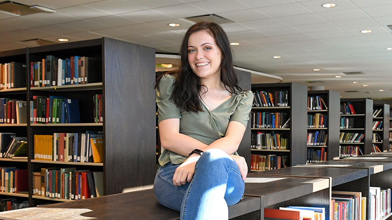 student in library