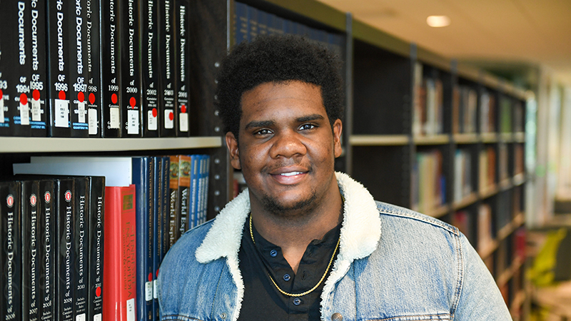 student in library