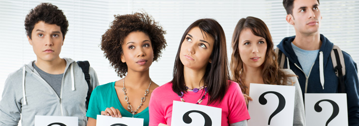 group of puzzled people hold question mark signs