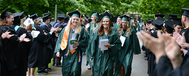 students and faculty at graduation