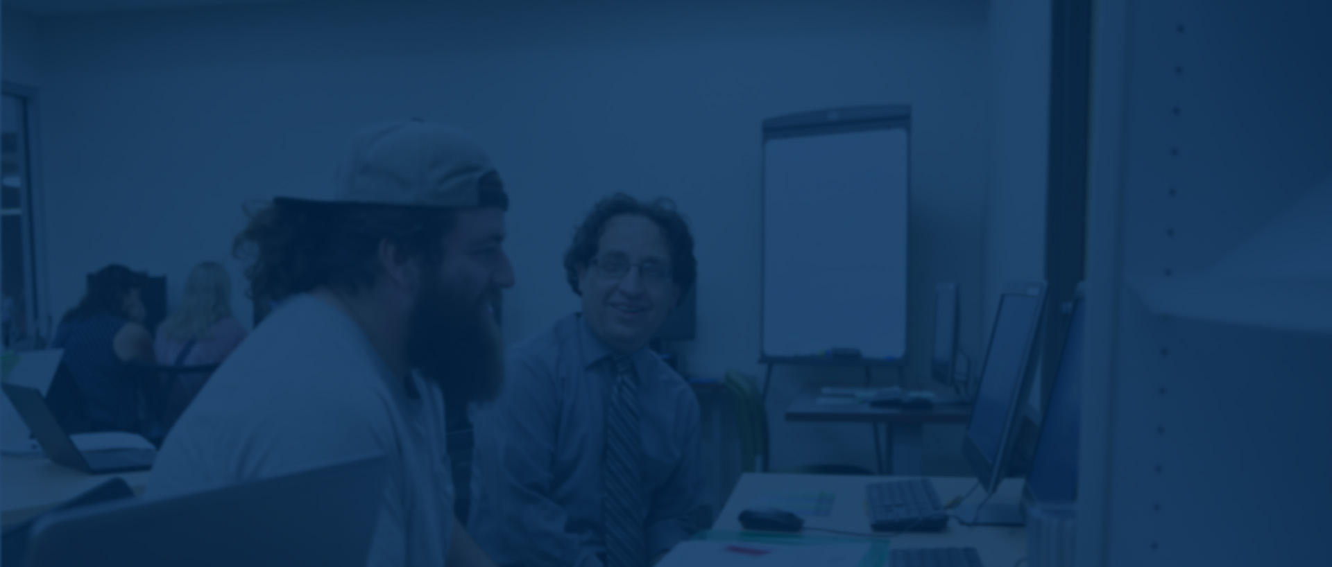 Male student work on computor with Advisor