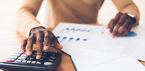 Someone using a calculator while handling paperwork