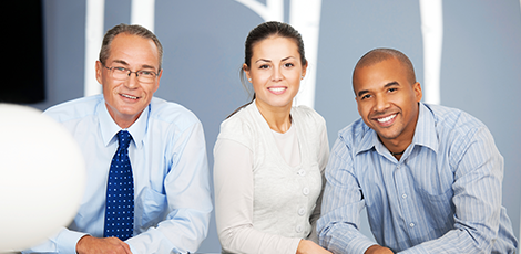 A group of three people smiling at the camera