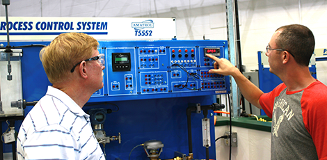 Two men examining an engineering machine