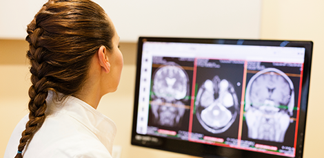 A woman looking at an MRI scan result on her computer