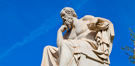 A marble statue of a bearded man thinking