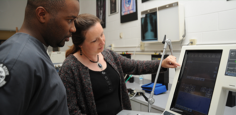 Two people looking at a medical computer