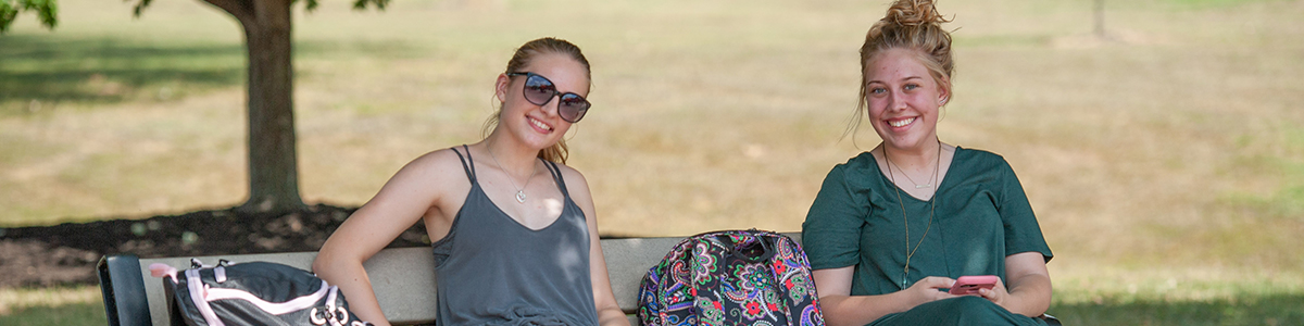 students sitting outside