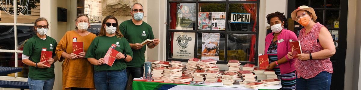 Columbia State staff with table of books