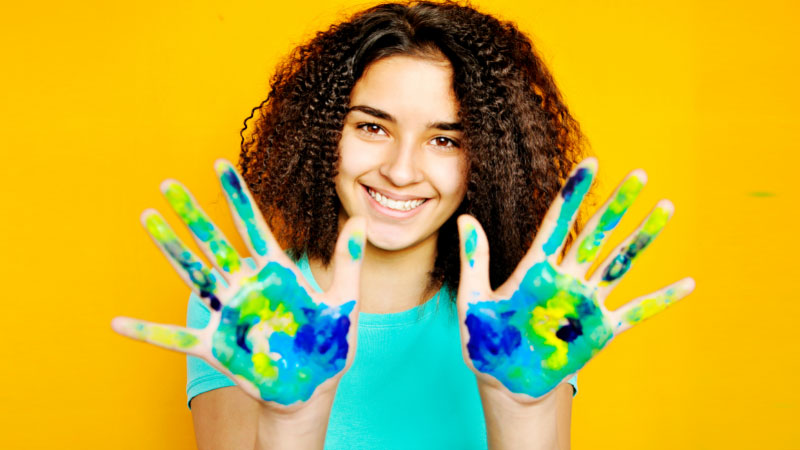 student with paint on hands
