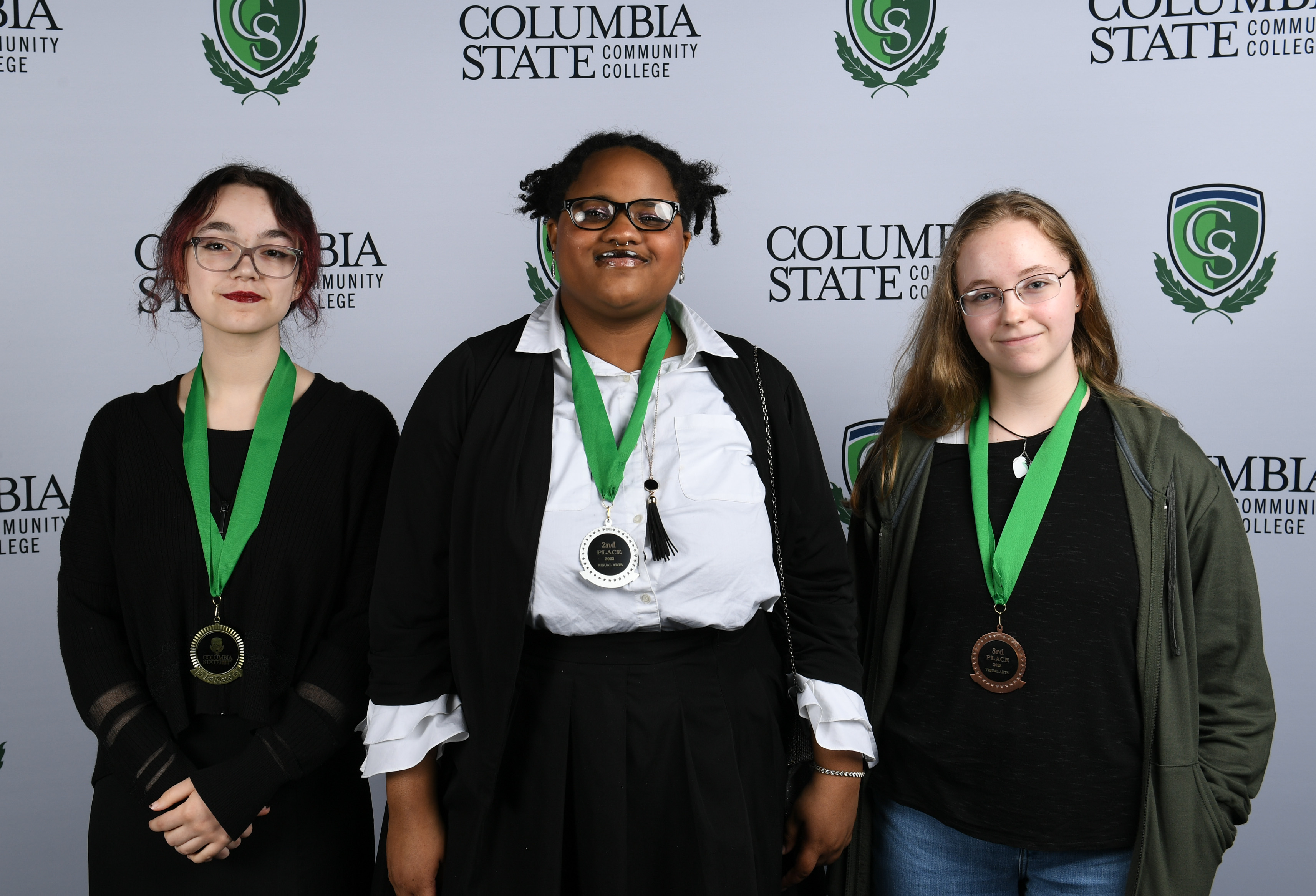 Visual Art Winners (left to right): First place winner, Rachel Sturges of Summit High School; second place winner, Adanna Buford of Santa Fe Unit School; and third place winner, Sarah McClure of Richland High School.