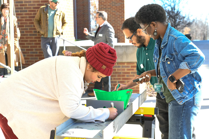 Columbia State staff add their signatures to a beam that will be inserted in the new Arts and Technology Building on Columbia State Community College’s Williamson Campus.