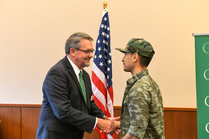 Dr. Dearl Lampley, Columbia State vice president of the Williamson Campus and external services, presents the 2022 Chancellor’s Commendation for Military Veterans to Joaquin Ortiz.