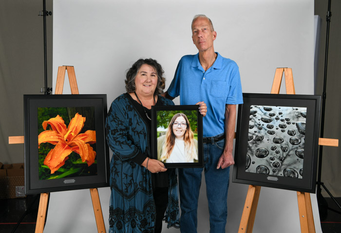 Penny and Greg May with their daughter Katherine May’s photography, which is now on display at Columbia State’s Williamson Campus.