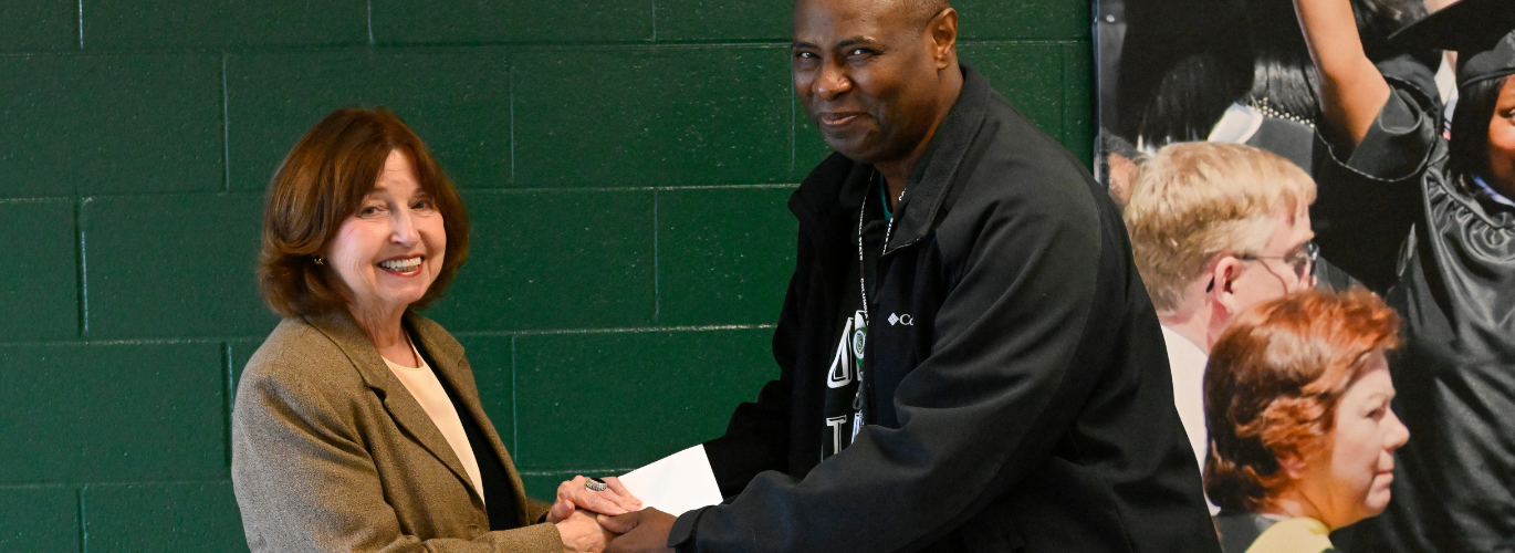 President Smith awards Kelvin Webster the Challenge Coin