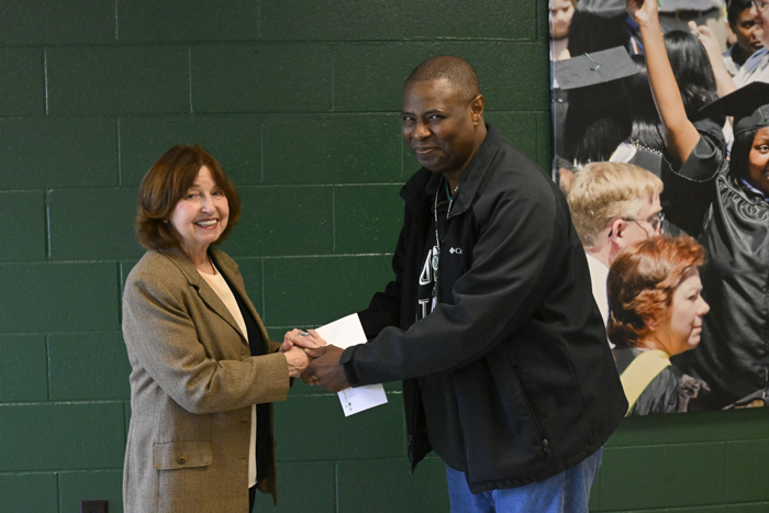 President Smith shakes hands with Kelvin Webster.
