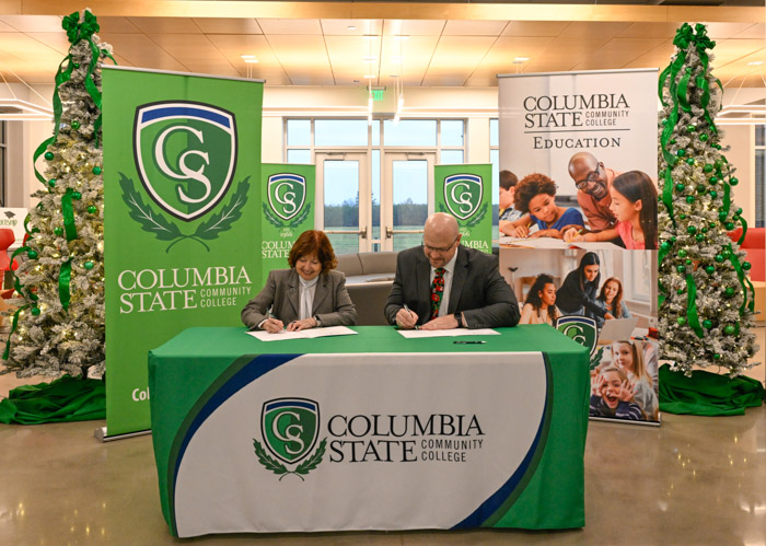 Dr. Janet F. Smith, Columbia State president and Michael Adkins, director of schools for Lawrence County sign the articulation agreement for the pre-apprenticeship training program for aspiring educators.