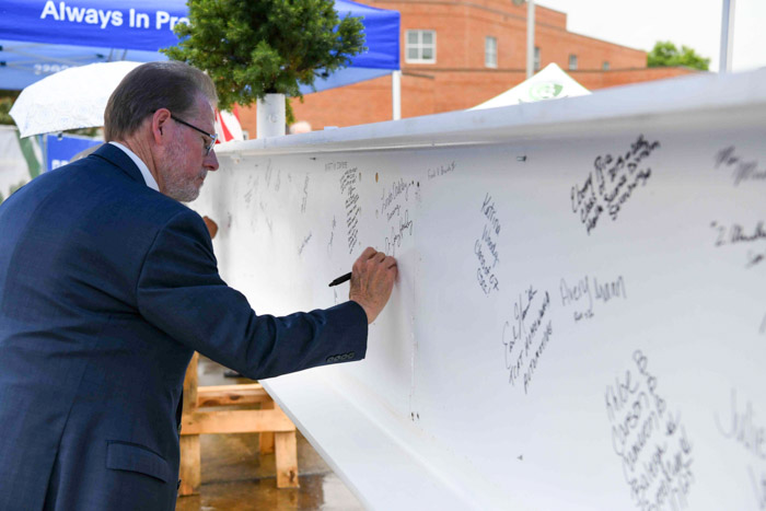 Tennessee State Senator Joey Hensley, a Columbia State alumnus, signs the “Topping Out” beam.