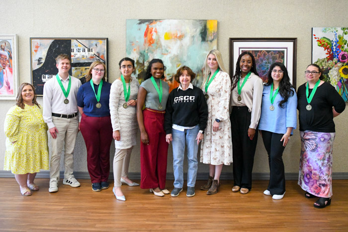 A group of people stand and pose for a photo.