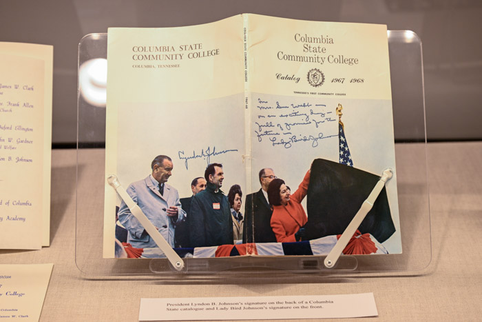 A close upshot shows a course catalog booklet with a photos of President Lyndon Johnson and Lady Bird Johnson.