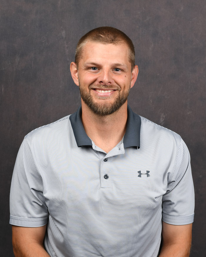 An employee smiles for a headshot.