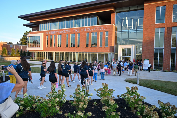 A line of people enter the Southern Regional Technology Center from the outside.