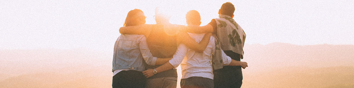 family on beach at sunset