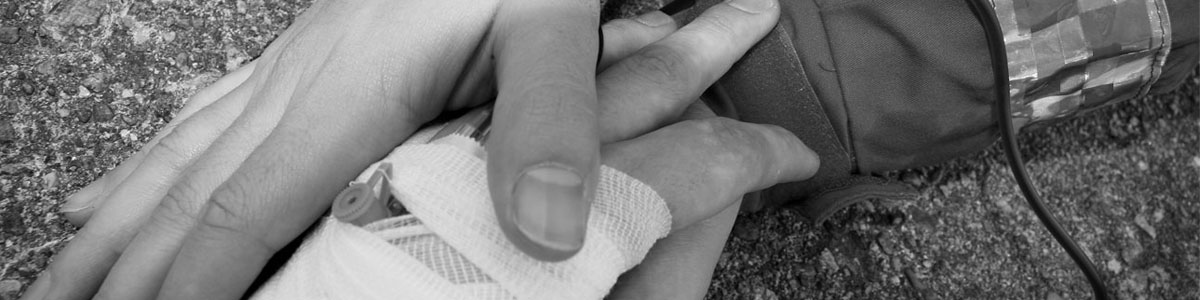 hand of EMT hold injured hand