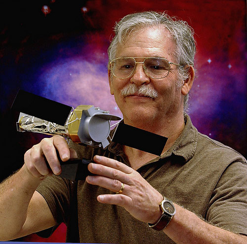 Man holding model of space telescope