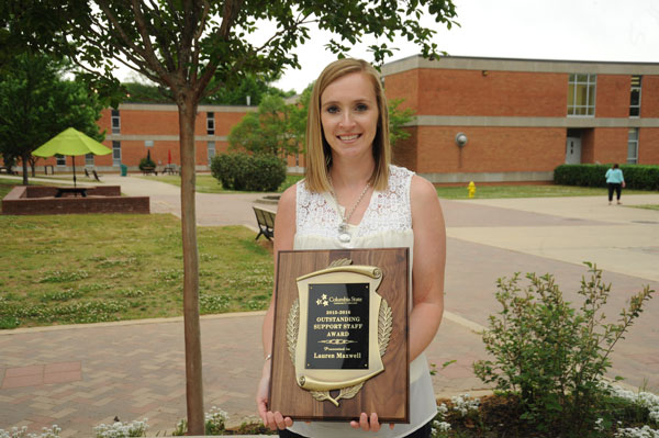 Employee holds award 