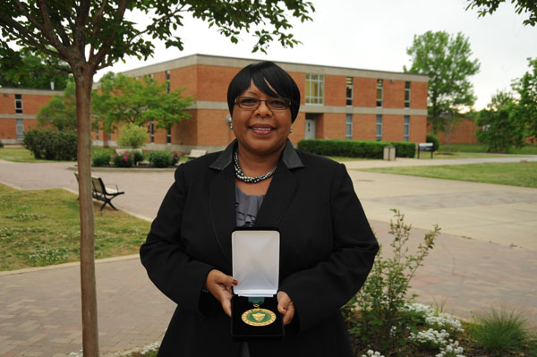 African American woman holding plaque