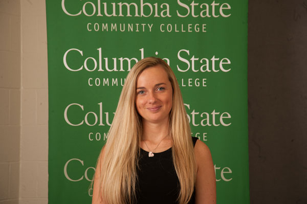 Blonde smiles in front of Columbia state background