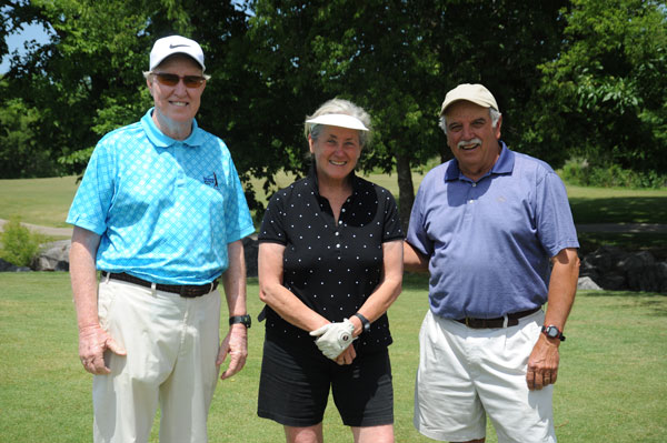 Two guys and a woman smile