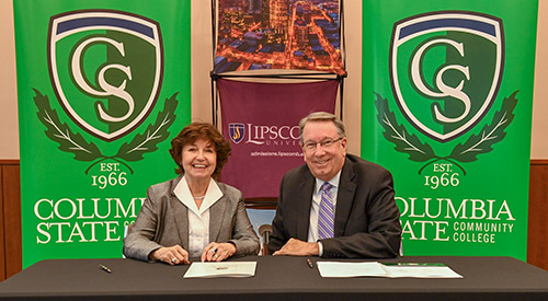 Dr. Janet F. Smith and Dr. L. Randolph Lowry sign partnership agreement