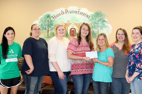 SKD giving check to Center of Hope