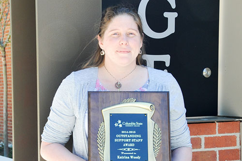 Katrina holding her outstanding support staff award