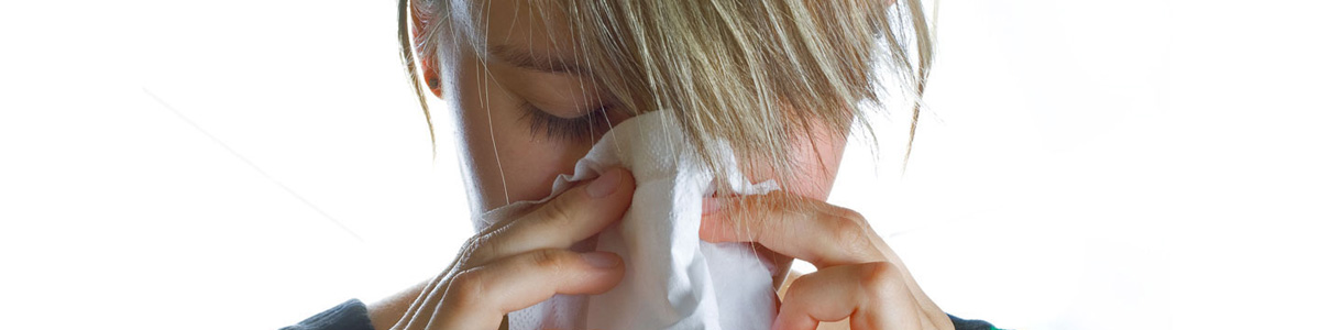 woman blowing nose