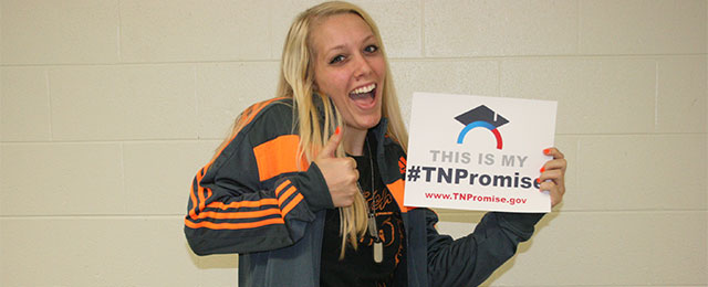 happy student with sign This is my TN Promise
