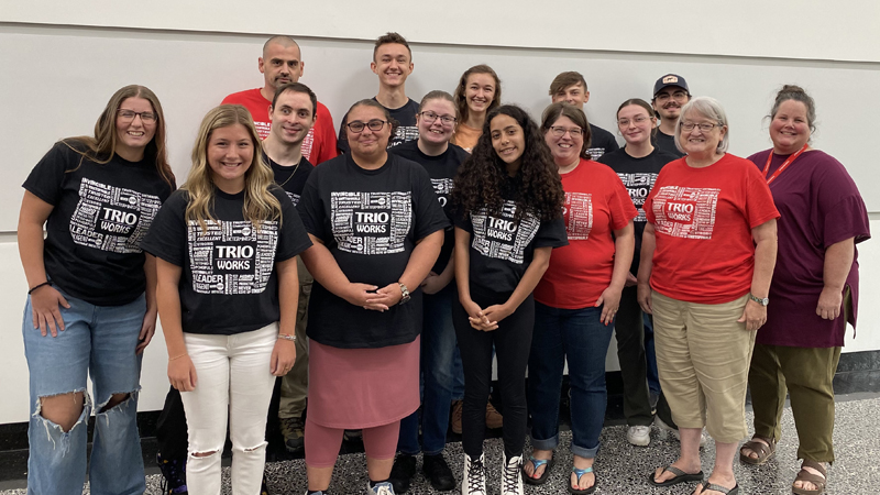 group of students and staff with Trio shirts