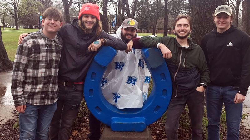 Several students standing around the MTSU horseshoe.