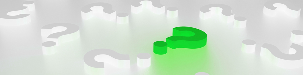 A glowing Green question mark stands out among several dark question marks on a white surface.